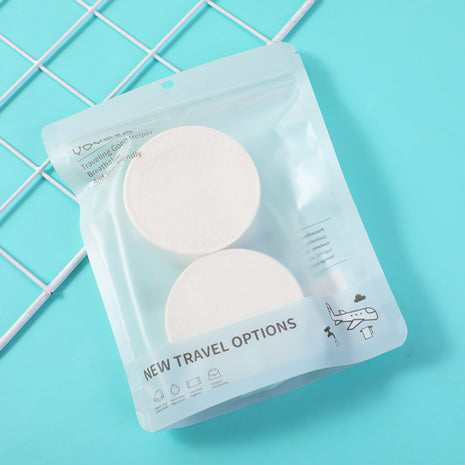 2 compressed bath towels (round).